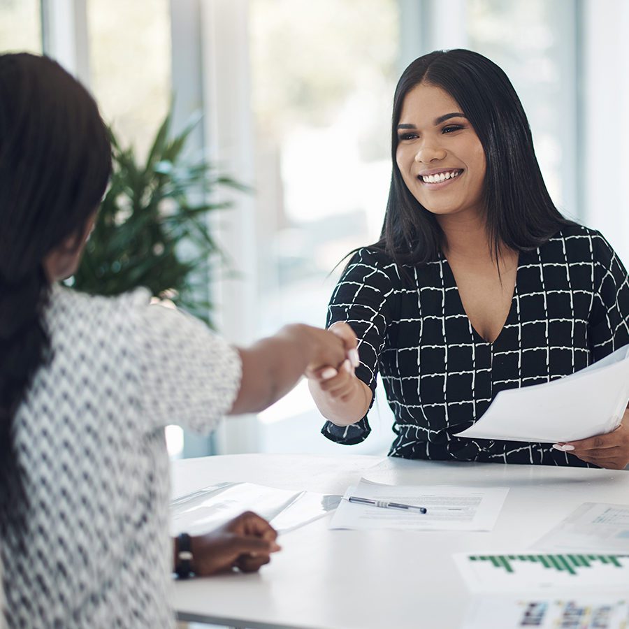 Woman Smiling Shaking Hand of Customer