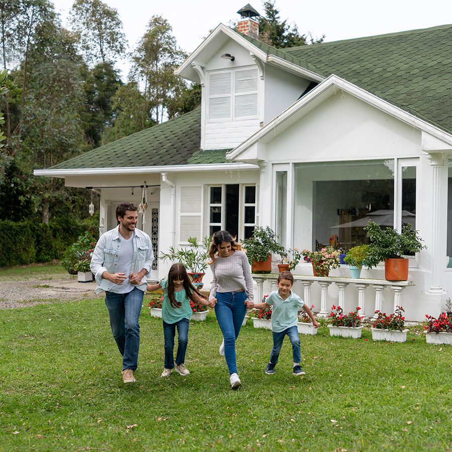 Family Running in Front of Their New Home