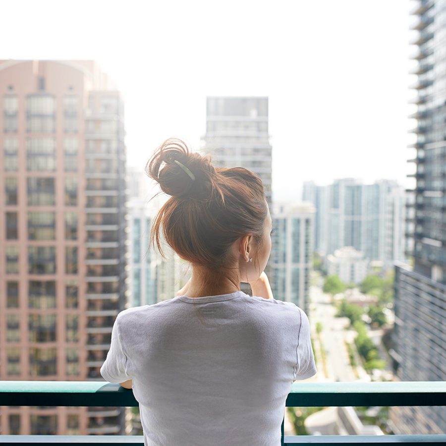 Woman Looking at View From Balcony