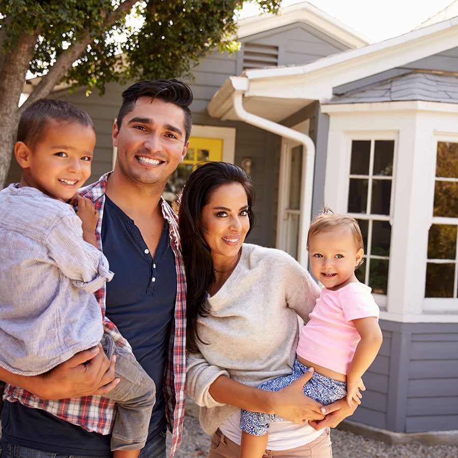 Young Family in Front of Their New Home