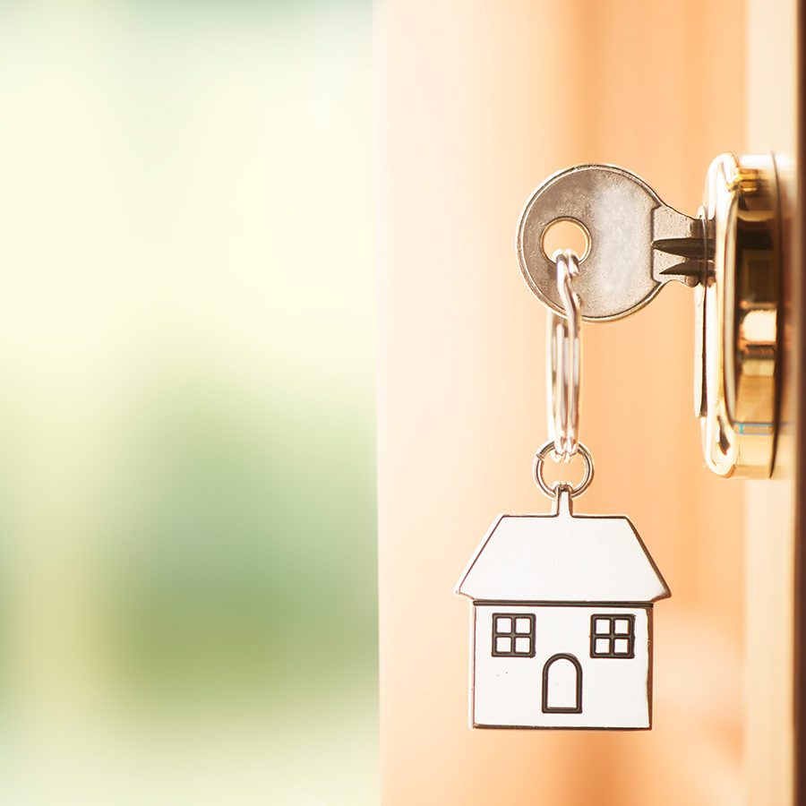 Key with House Keychain in Door Lock