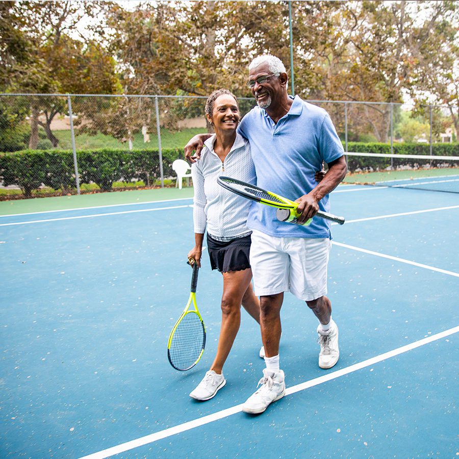Senior Couple Walking Off a Tennis Court