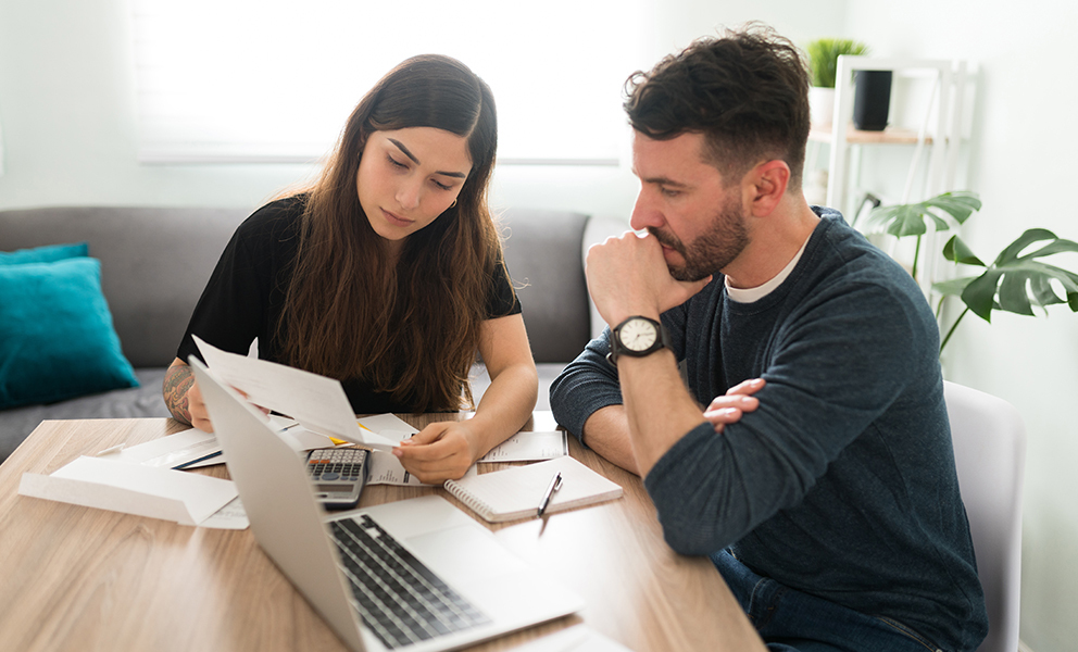 Man and woman going over documents at kitchen table