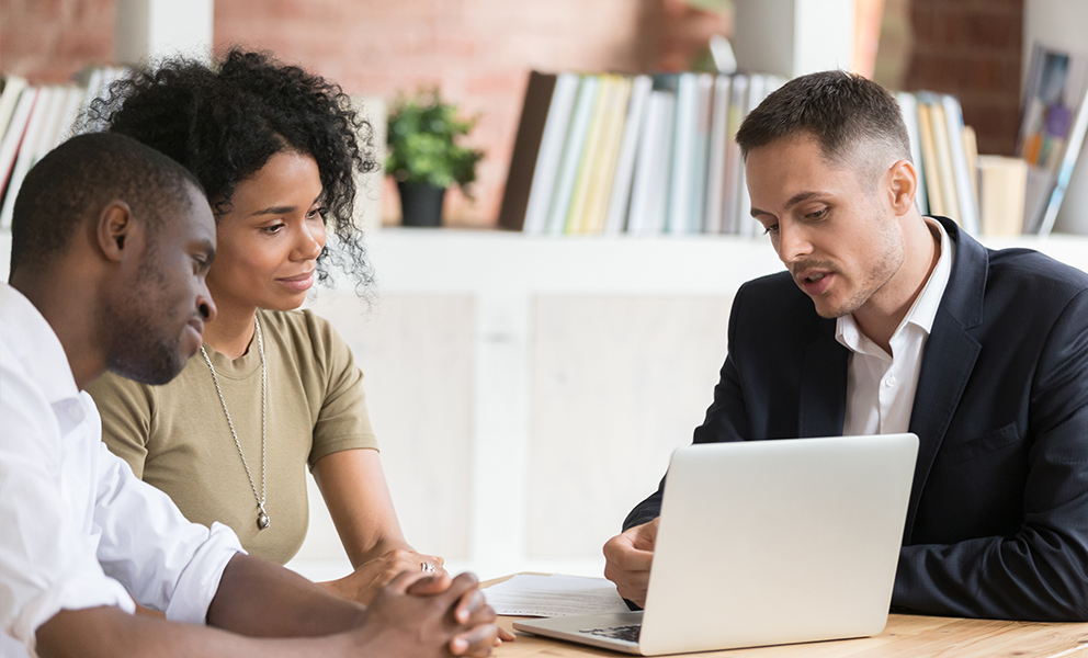Loan officer explaining financial documents to couple