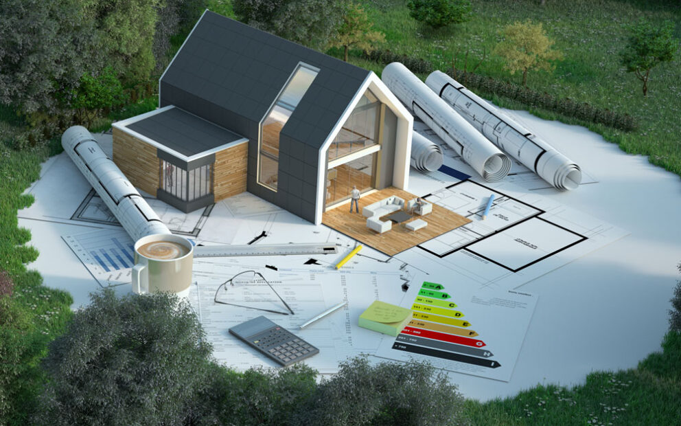 Model house with paperwork and blueprints surrounded by land and vegetation