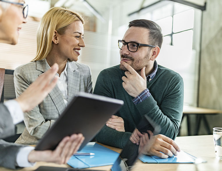 Unsure-Couple-asking-questions-to-banker