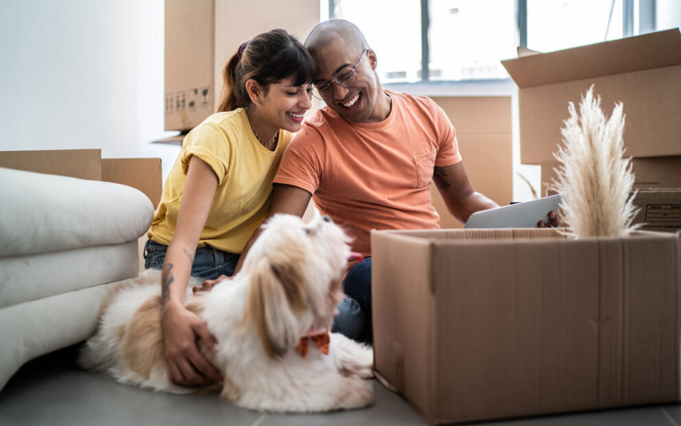 Couple enjoying moving into their new home with their dog.