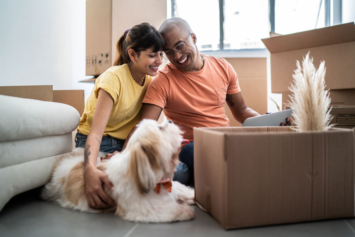 Couple enjoying moving into their new home with their dog.