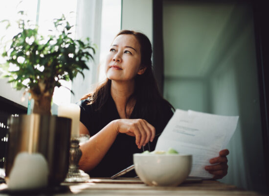 Woman looking over her finances and pondering her options.