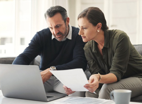 couple reviewing their documents on their couch