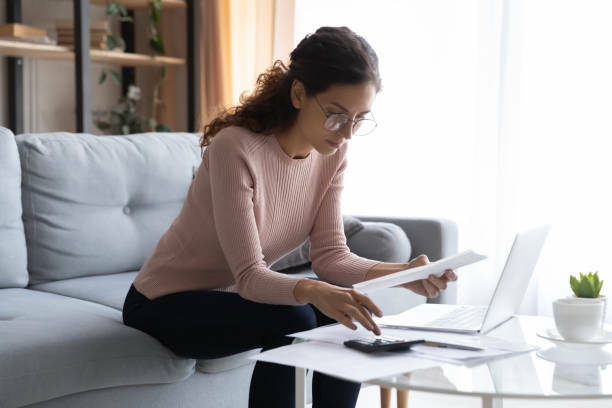 Woman reviewing her financials at home.