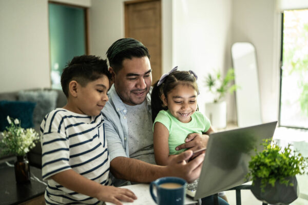 Young Latino family looking at a computer together.