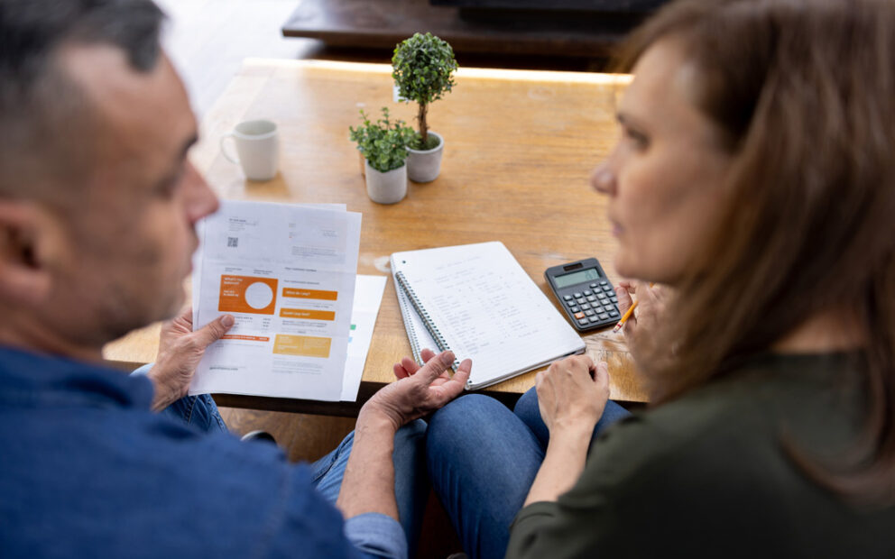 Couple sitting together discussing their finances.