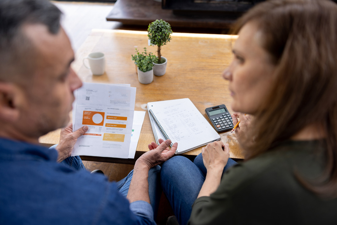 Couple sitting together discussing their finances.