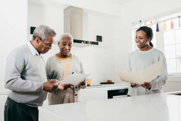Senior couple discussing their finances/home options with a business woman.