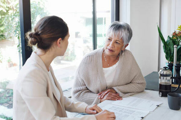 Senior woman listening to financial advisor about her options.