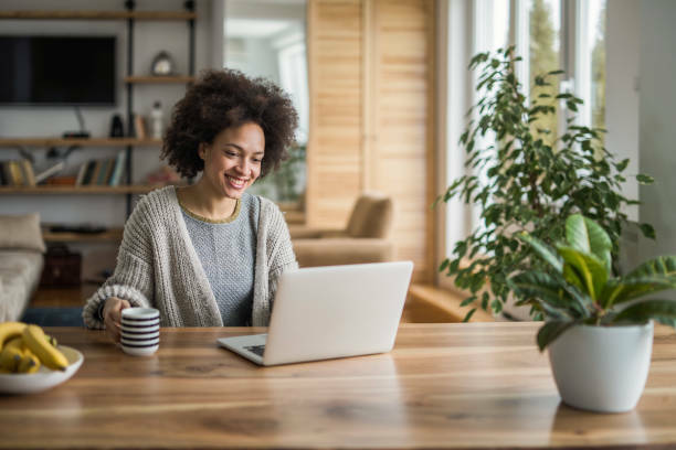 Young woman looking at her laptop at her desk