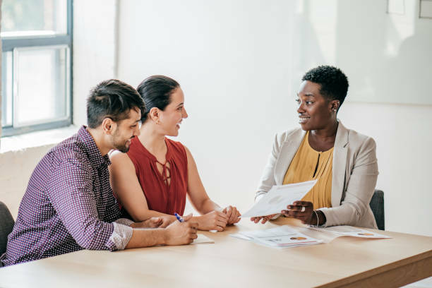 Couple discussing their finances with a businesswoman