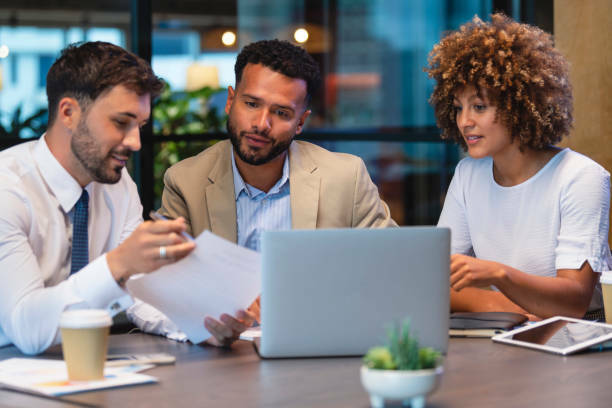 Couple discussing their finances with a businessman