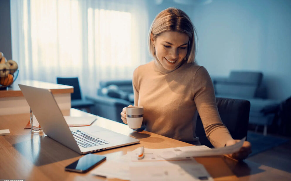 Young woman looking at documents at her desk