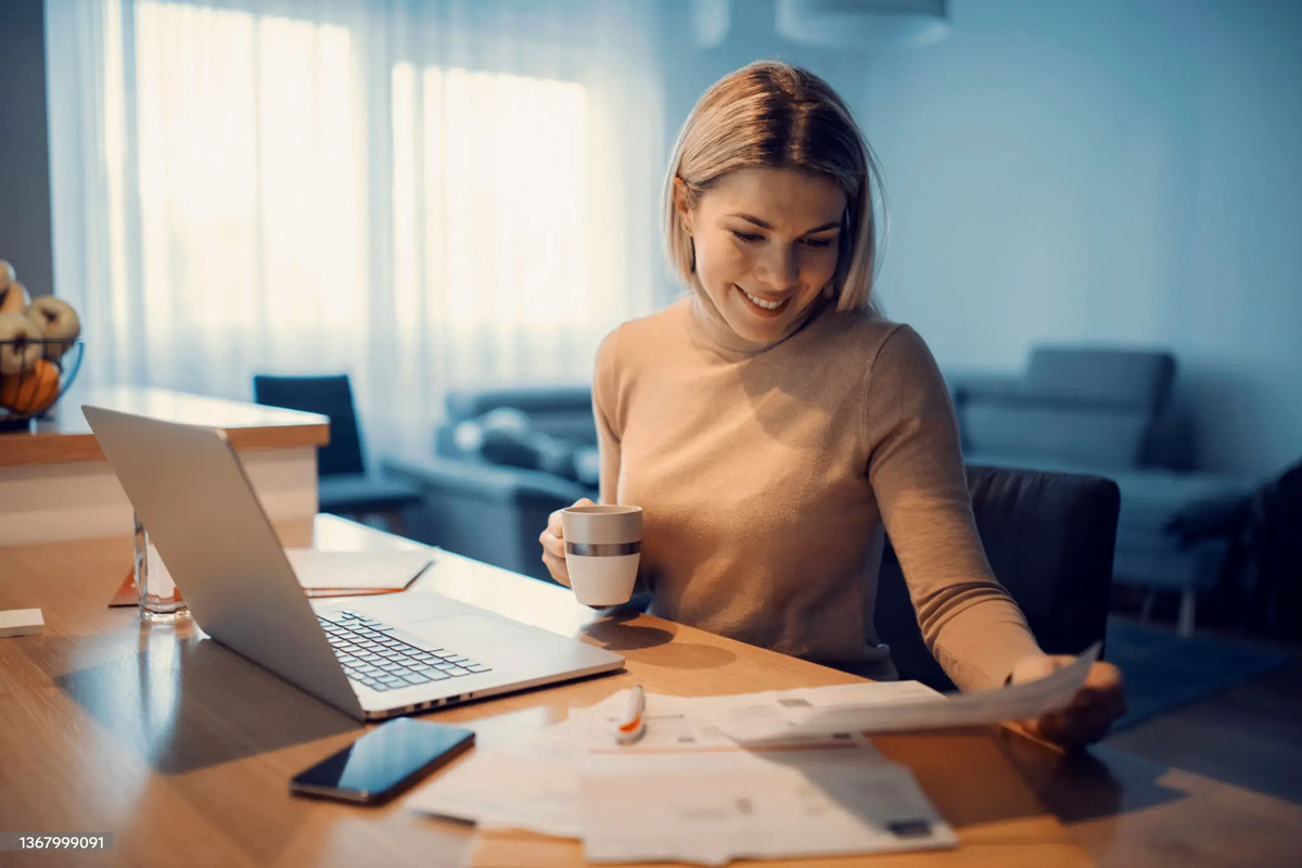 Young woman looking at documents at her desk