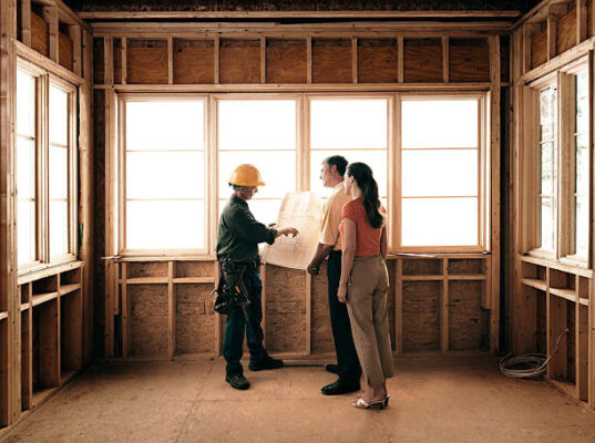 Couple on a construction site of their future new home.