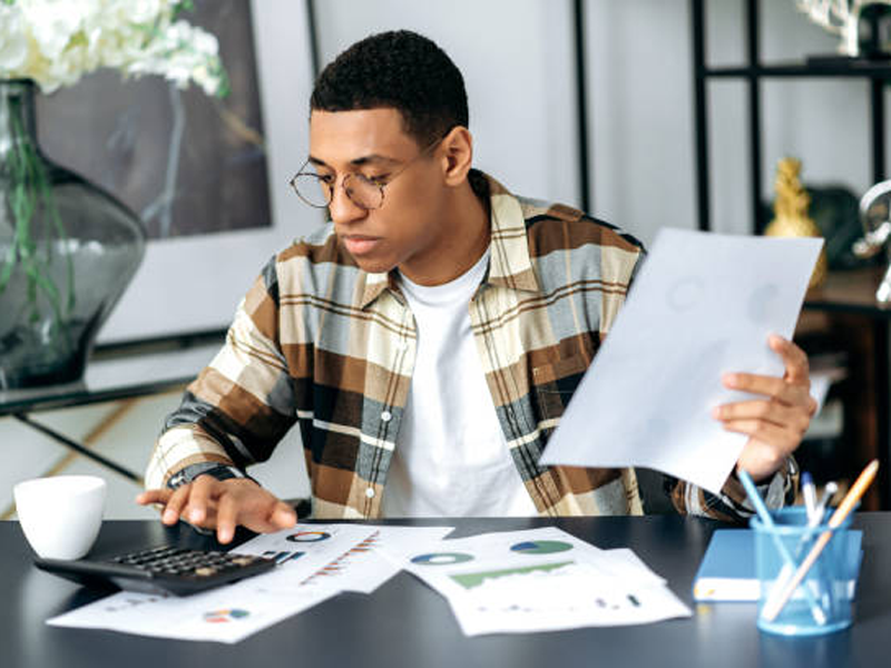 Man doing math and looking at documents