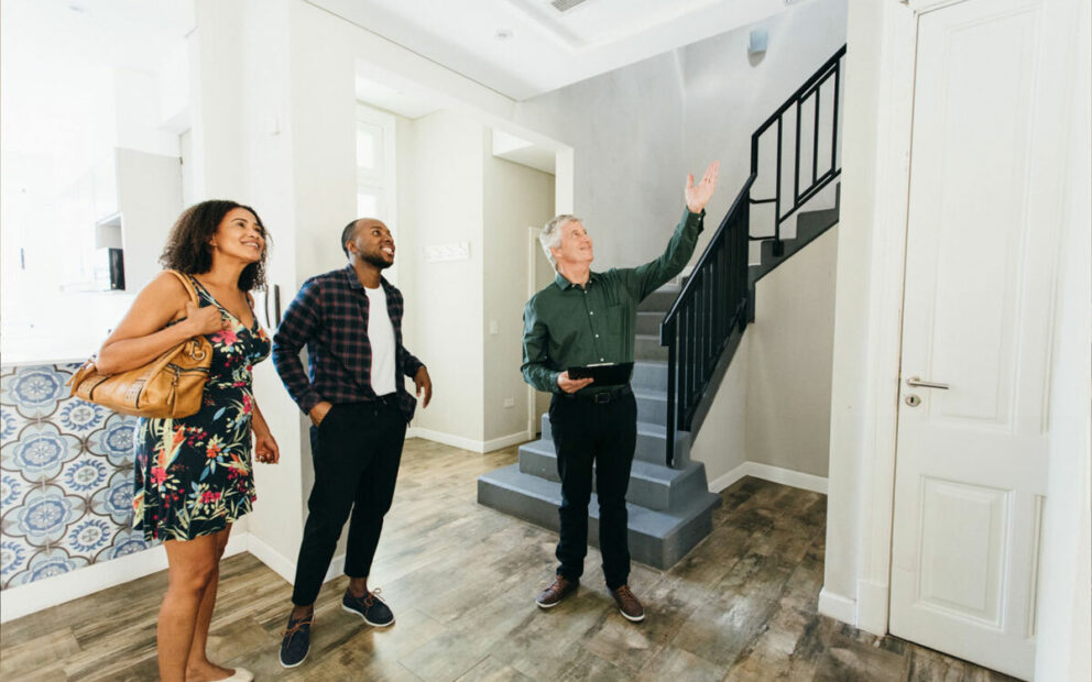 Couple touring a home with real estate agent
