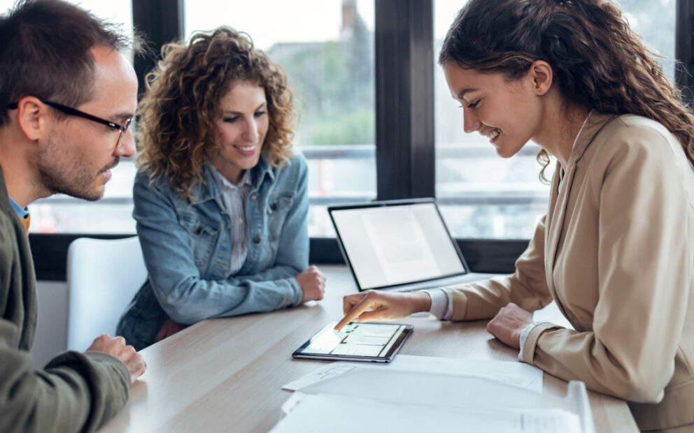 Couple reviewing documents with advisor