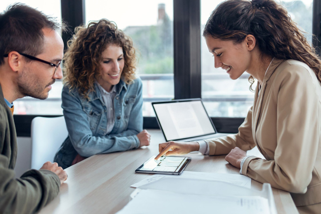 Couple reviewing documents with advisor