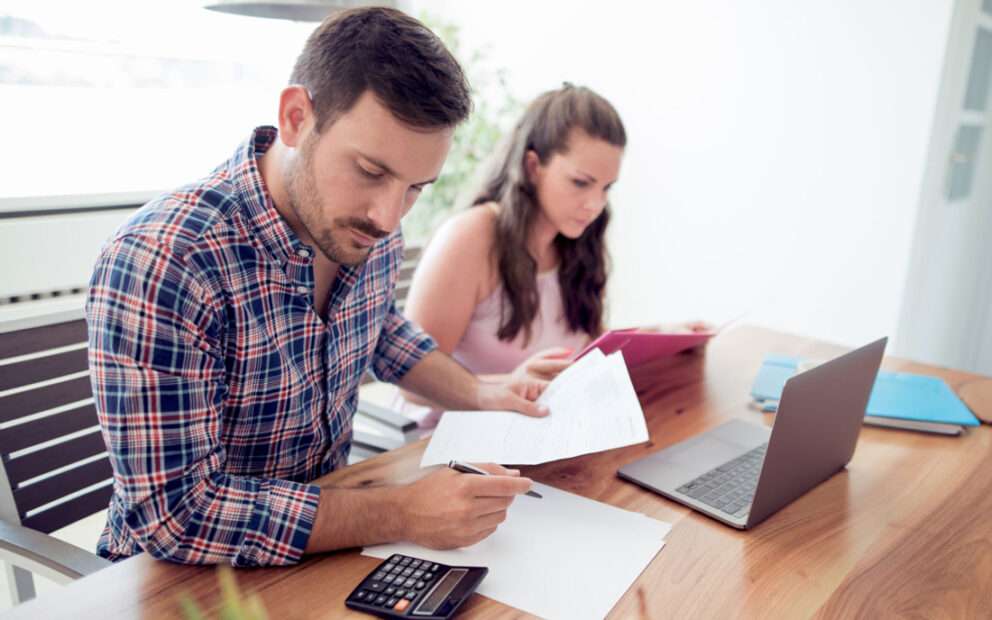 Man and woman at a desk reviewing documents together