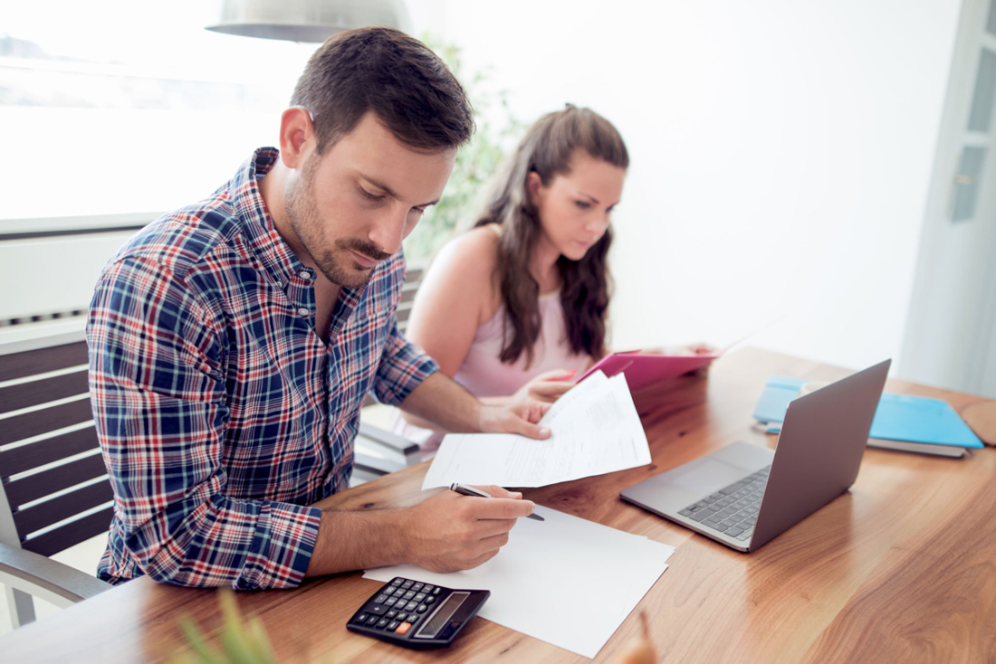 Man and woman at a desk reviewing documents together