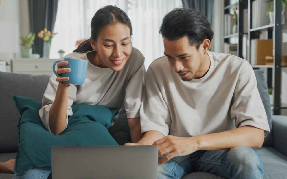 Man and woman reviewing finances on laptop