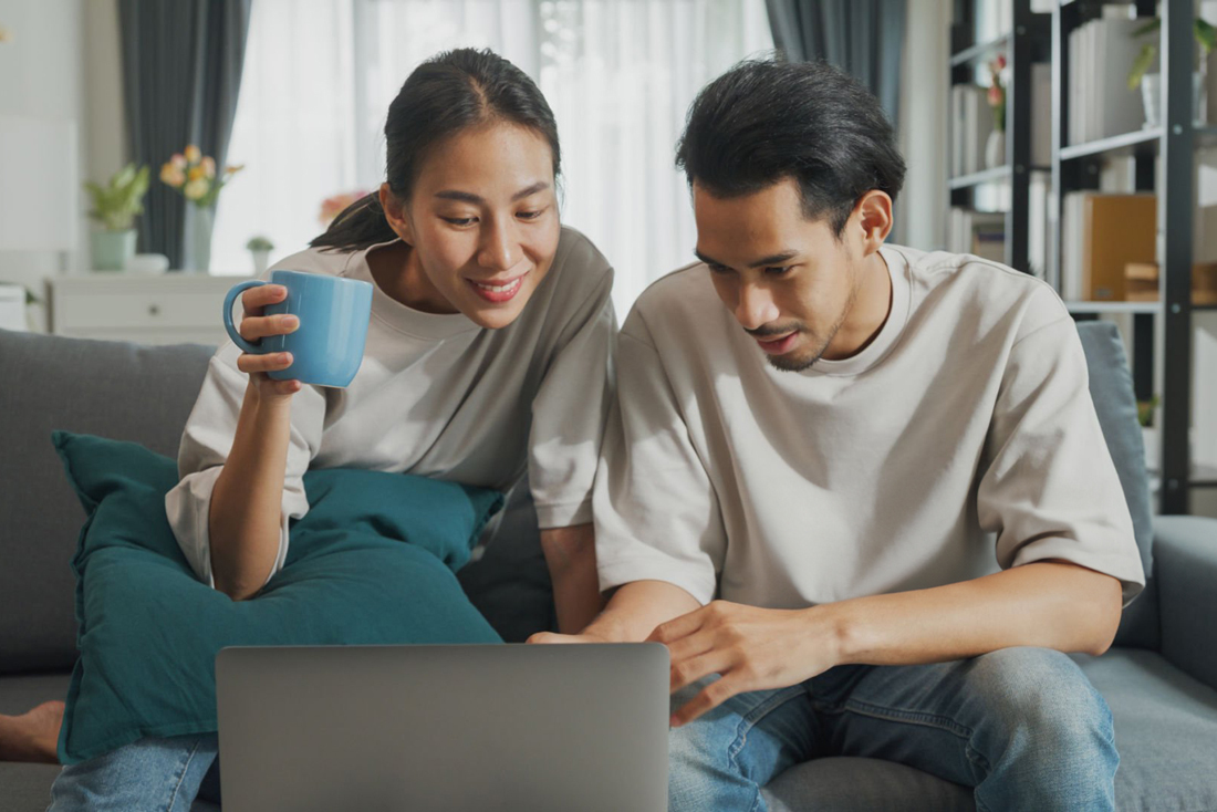 Man and woman reviewing finances on laptop