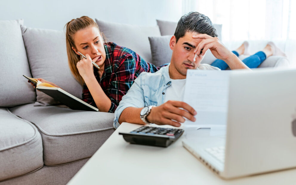 Man and woman stressed and reviewing documents