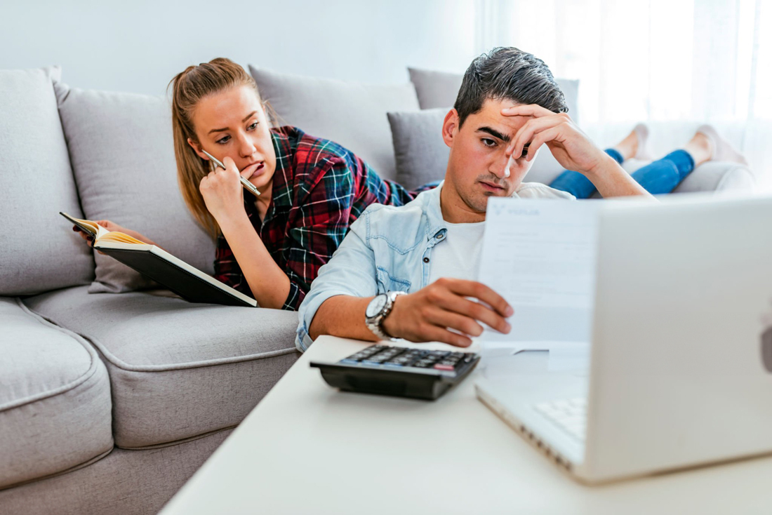 Man and woman stressed and reviewing documents