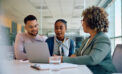 Couple looking over documents with advisor