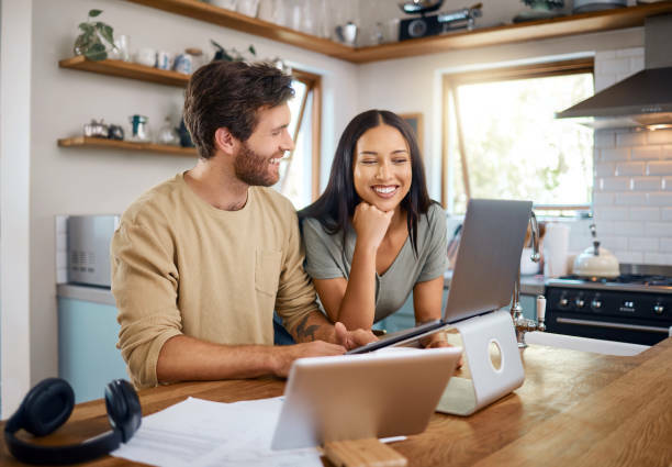 Man and woman enjoying reviewing finances in the kitchen