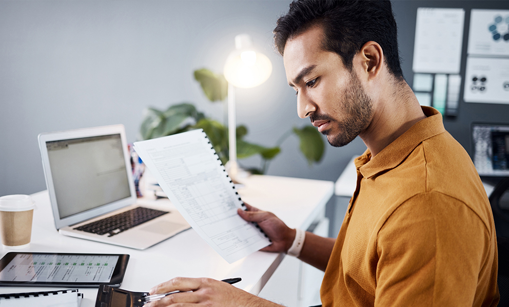 Man reviewing his financial documents in home office