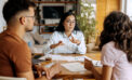 Woman professional explaining documents to couple at table