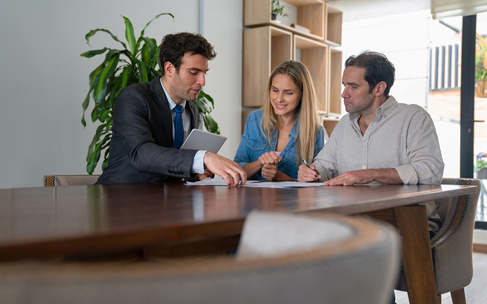 Couple reviewing documents with advisor