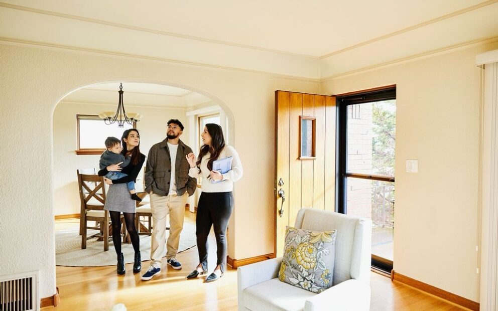 Family looking at house with real estate agent
