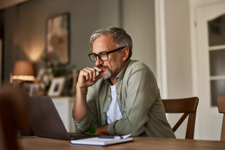 Man researching on laptop