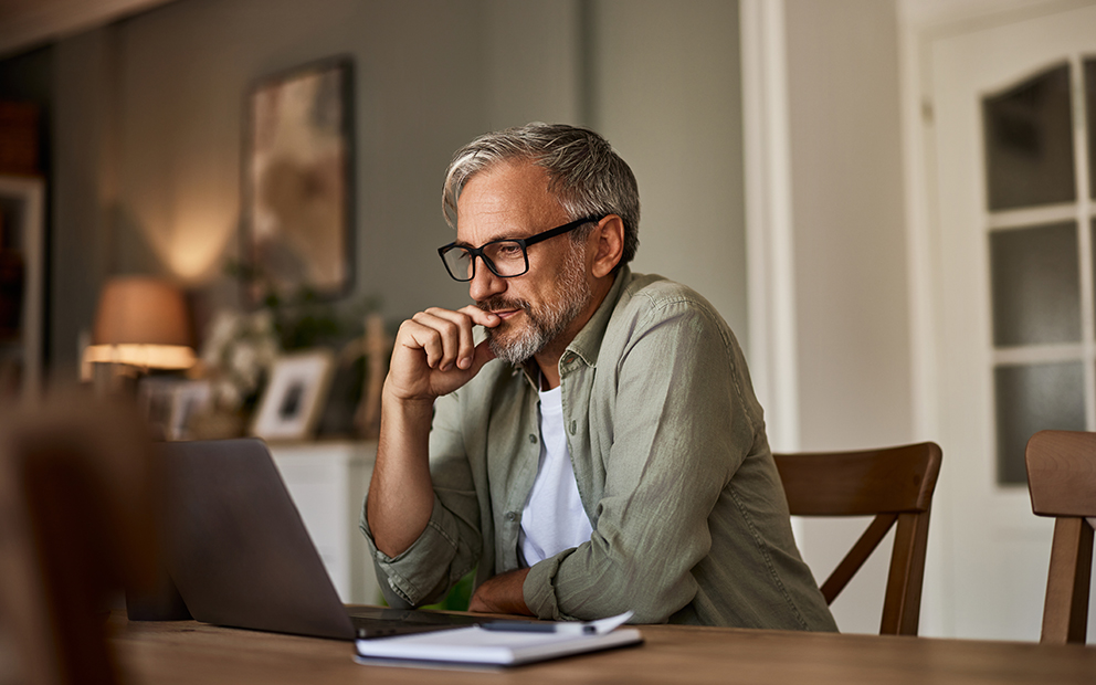 Man researching on laptop