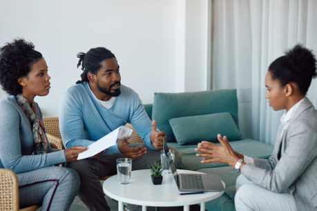 Couple sitting down and speaking with lender