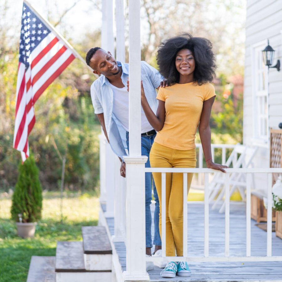 Couple on porch with American flag
