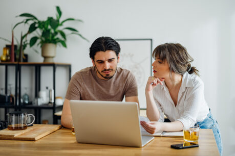 Couple sitting together while reviewing finances