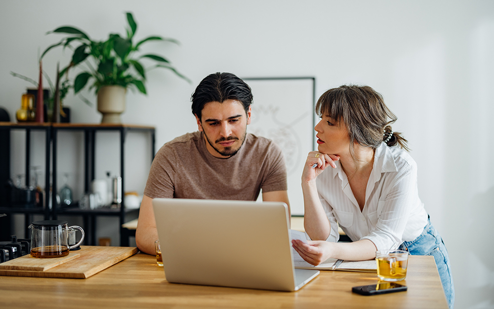 Couple sitting together while reviewing finances