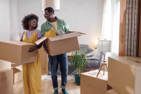 Couple smiling as they pack up their home