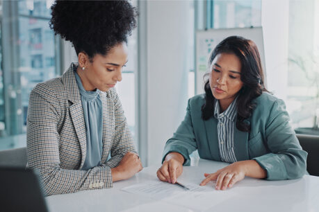 Woman speaking with advisor as they review documents together